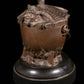 bronze forming a covered pot a devil in a cauldron - RELICS